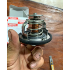 Close-up side view of Isuzu thermostat with spring assembly and black sealing ring