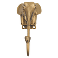 Brass elephant head wall hook held in hand showing compact size and hook detail