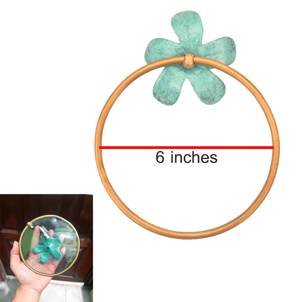 Brass flower towel ring with 6-inch diameter measurement shown, held in hand for scale