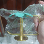 Rear view of brass toilet paper holder and round wall mounting plate