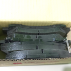 Isuzu front brake pads arranged inside packaging